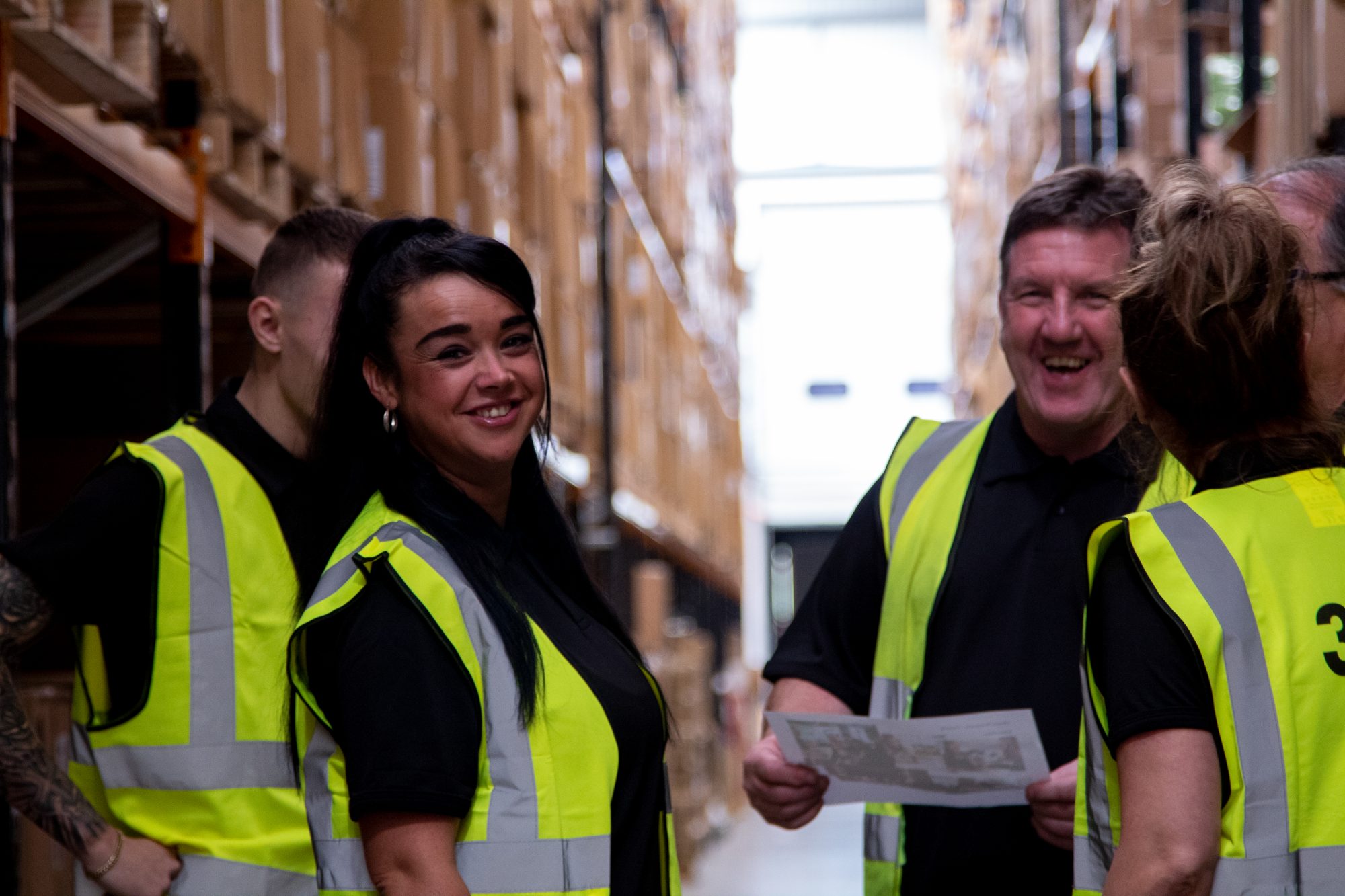 people smiling whilst working at a 3PL warehouse