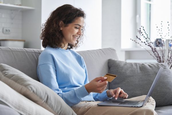 D2C fulfilment,Happy,Hispanic,Young,Woman,Consumer,Holding,Credit,Card,And,Laptop