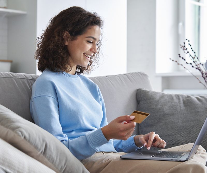 D2C fulfilment,Happy,Hispanic,Young,Woman,Consumer,Holding,Credit,Card,And,Laptop